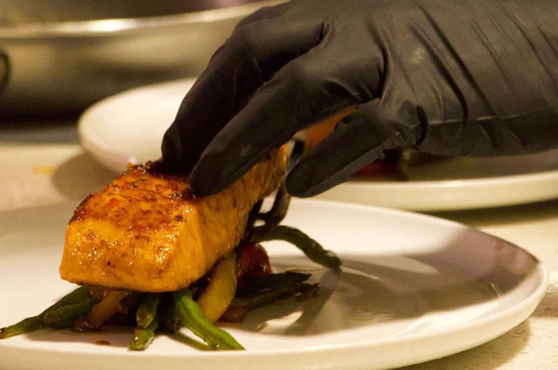 Chef Quay plating seared salmon with green beans