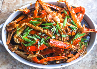 Crab legs in a rich seafood bisque topped with green onions